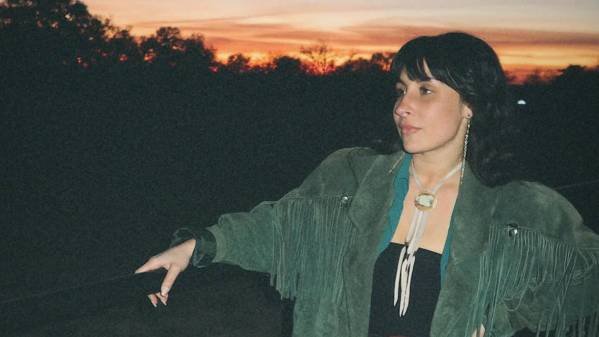 Mackenzie Palladino of Semplicé Designs wearing her handmade jewelry at sunset