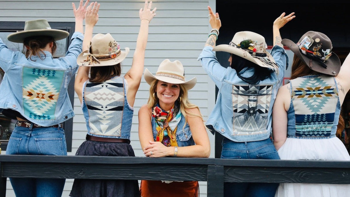 Shelby West of Three Sons smiling in the center of friends wearing her Pendleton-backed denim jackets